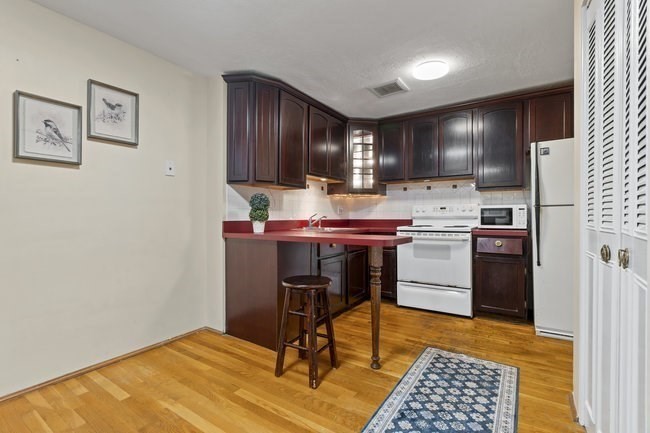 357 Faneuil Street, Unit 12 Boston, MA 02135 - Photo 5 of 15 a kitchen that has a sink and cabinets