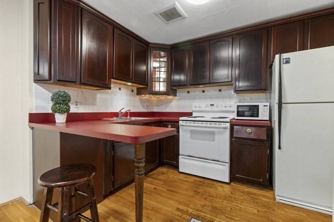 357 Faneuil Street, Unit 12 Boston, MA 02135 - Photo 8 of 15 a kitchen with stainless steel appliances a stove a refrigerator and cabinets