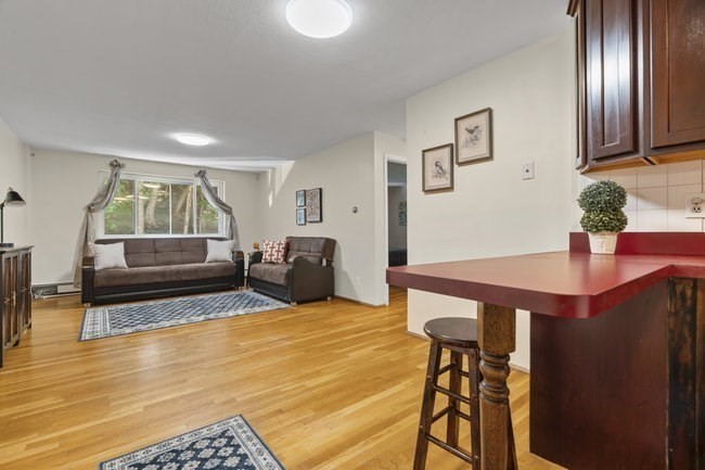 357 Faneuil Street, Unit 12 Boston, MA 02135 - Photo 10 of 15 a living room with furniture and wooden floor