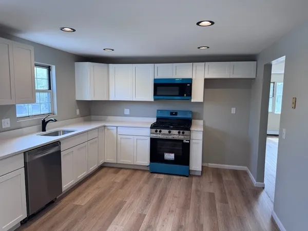 a kitchen with stainless steel appliances a stove a sink and a refrigerator