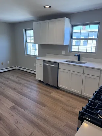 a kitchen with granite countertop a stove and a sink