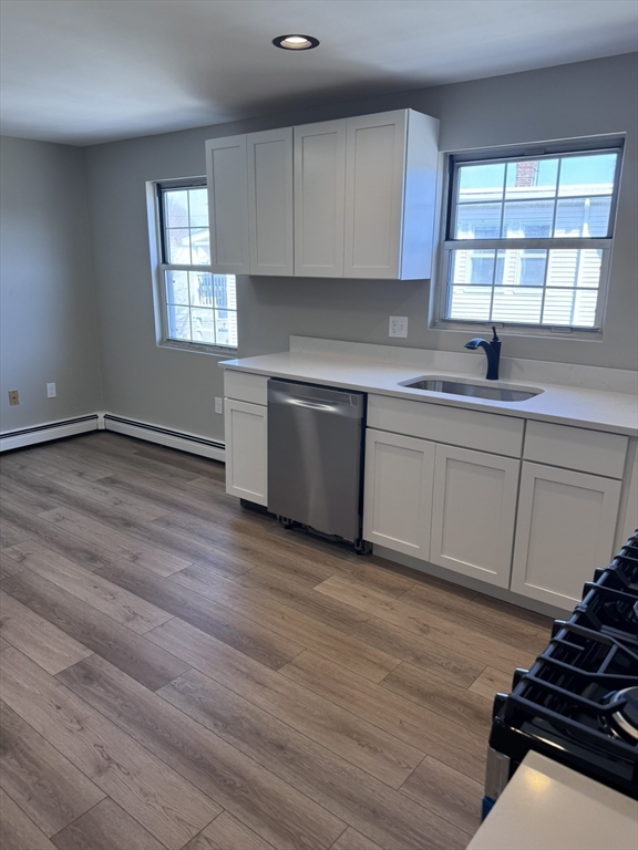 1099 River Street, Unit 3 Boston, MA 02136 - Photo 2 of 10 a kitchen with granite countertop a stove and a sink