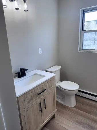 a white toilet sitting next to a bathroom sink