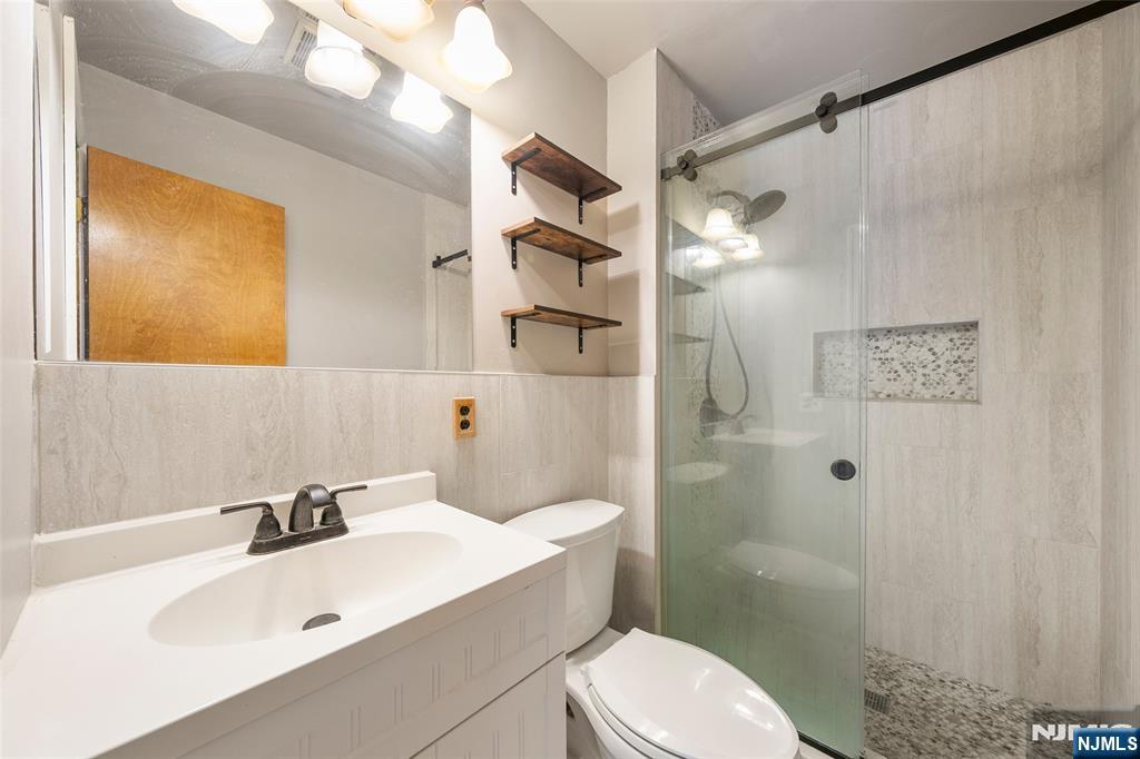 140 Allwood Road, Unit C Clifton, NJ 07012 - Photo 22 of 31 a bathroom with a sink a toilet and shower