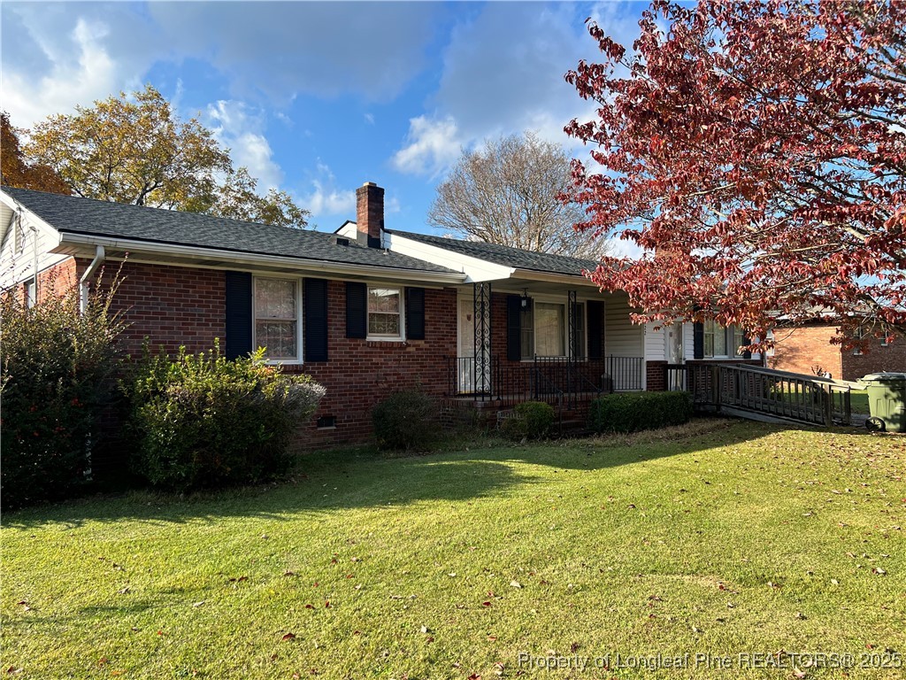 122 Bunker Hill Road Fayetteville, NC 28314 - Photo 1 of 16 a front view of a house with garden