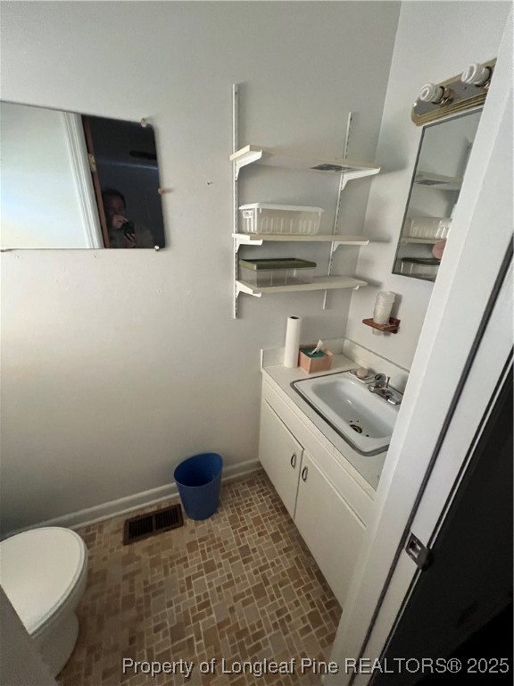 122 Bunker Hill Road Fayetteville, NC 28314 - Photo 13 of 16 a bathroom with a sink a toilet and a mirror