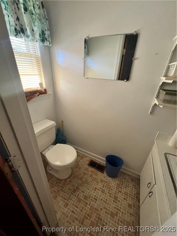 122 Bunker Hill Road Fayetteville, NC 28314 - Photo 14 of 16 a bathroom with a toilet a sink and a mirror