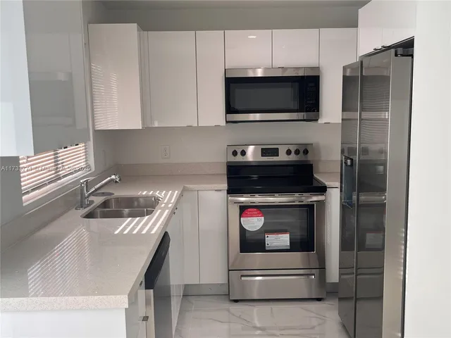 a kitchen with a stove and a microwave
