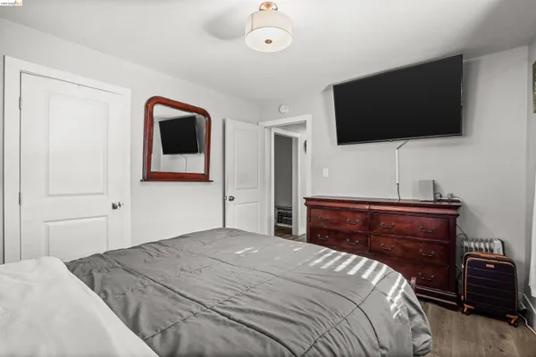 a bedroom with a bed and a flat screen tv