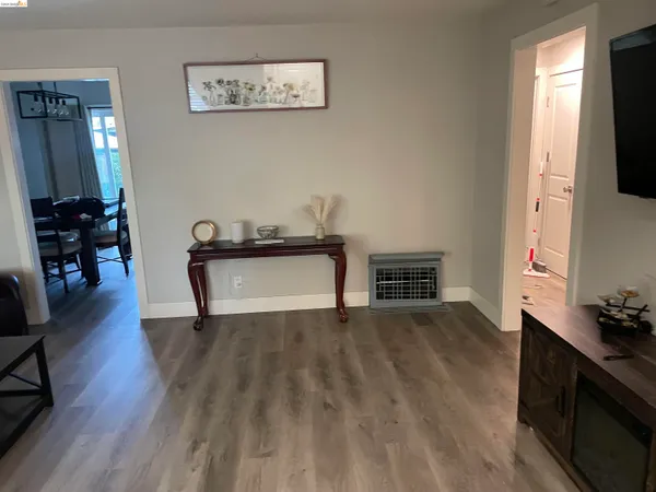 a view of a room with wooden floor and furniture