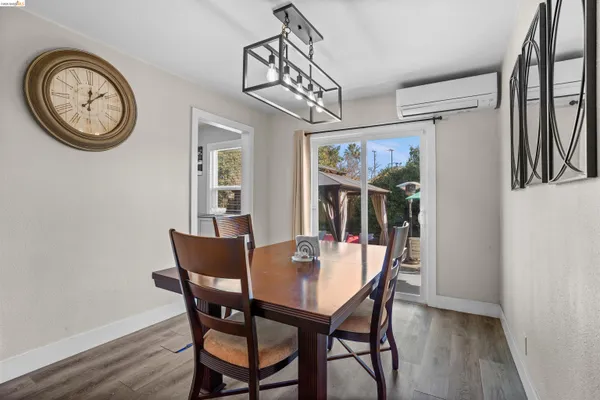 a view of a dining room with furniture and a chandelier