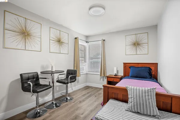 a bedroom with furniture and wooden floor