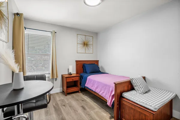 a bedroom with a bed and a desk