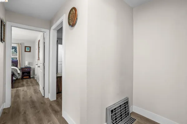 a view of room with wooden floor