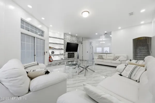 a living room with furniture and a flat screen tv