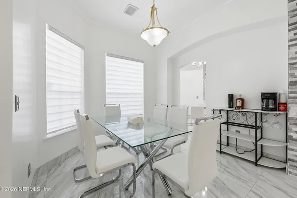 a view of a workspace with furniture and window