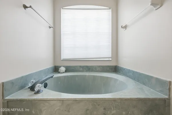 a white bath tub sitting next to a window