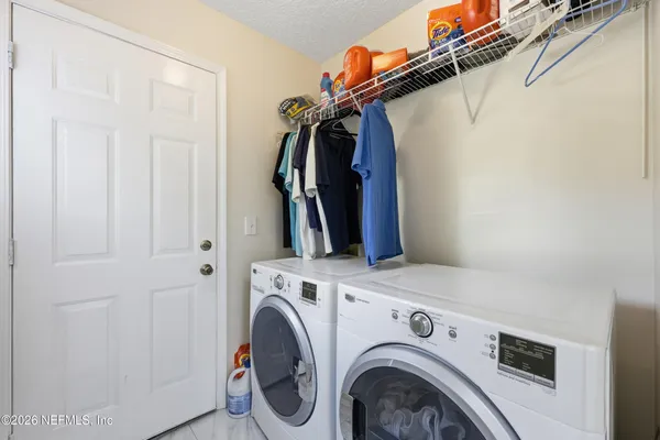 a view of storage and utility room with washer and dryer