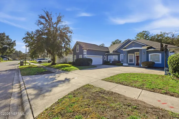 a front view of a house with a garden