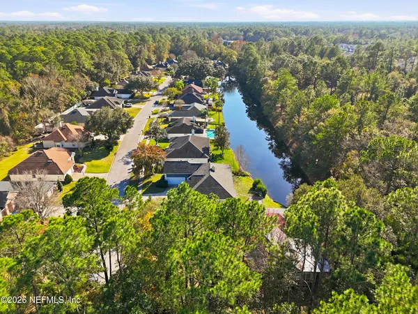 an aerial view of residential house with an outdoor space and seating