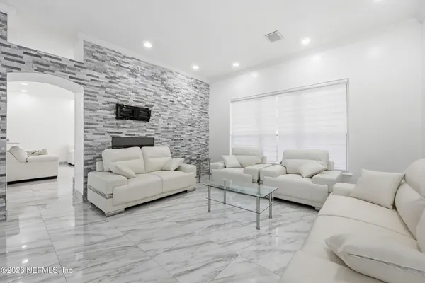 a living room with furniture and a flat screen tv
