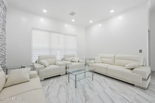 a living room with furniture and a large window