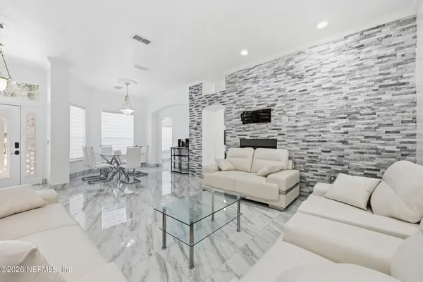 a living room with furniture and a flat screen tv