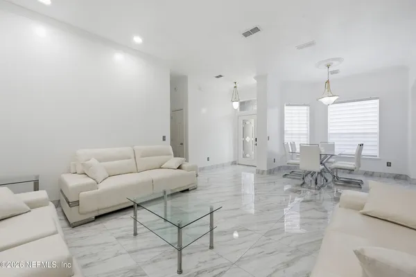 a living room with furniture and a large window