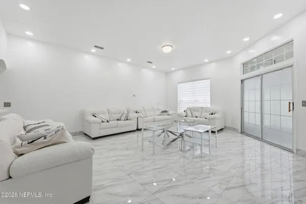a living room with furniture and white walls