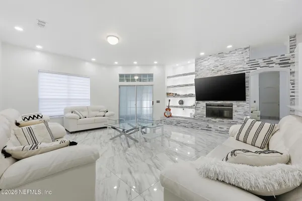 a living room with furniture and a flat screen tv