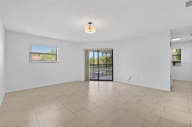 an empty room with a empty space and windows