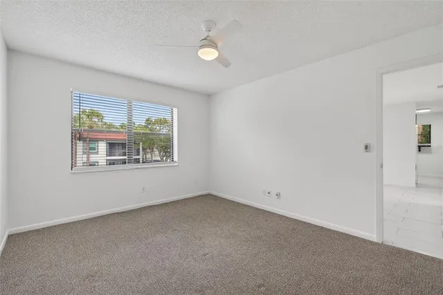 a spacious bathroom with a granite countertop sink mirror and a bathtub
