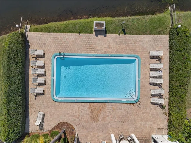 an aerial view of residential houses with outdoor space and trees