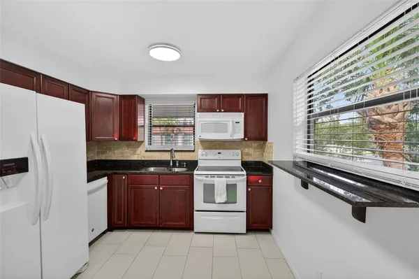 a kitchen with a stove and a window
