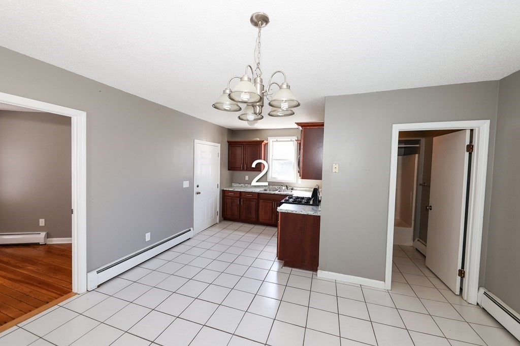 459 Snell Street Fall River, MA 02721 - Photo 11 of 42 a view of a kitchen with microwave and cabinets