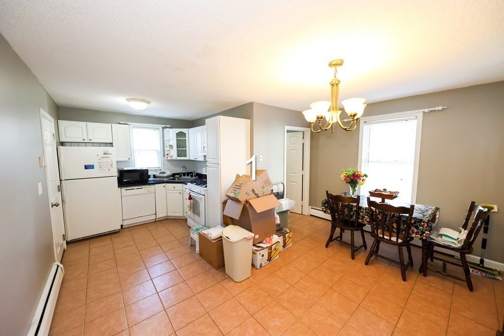 459 Snell Street Fall River, MA 02721 - Photo 14 of 42 a living room with furniture and a chandelier