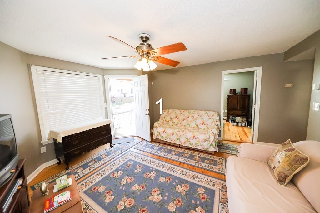 459 Snell Street Fall River, MA 02721 - Photo 15 of 42 a bedroom with a bed and a chandelier