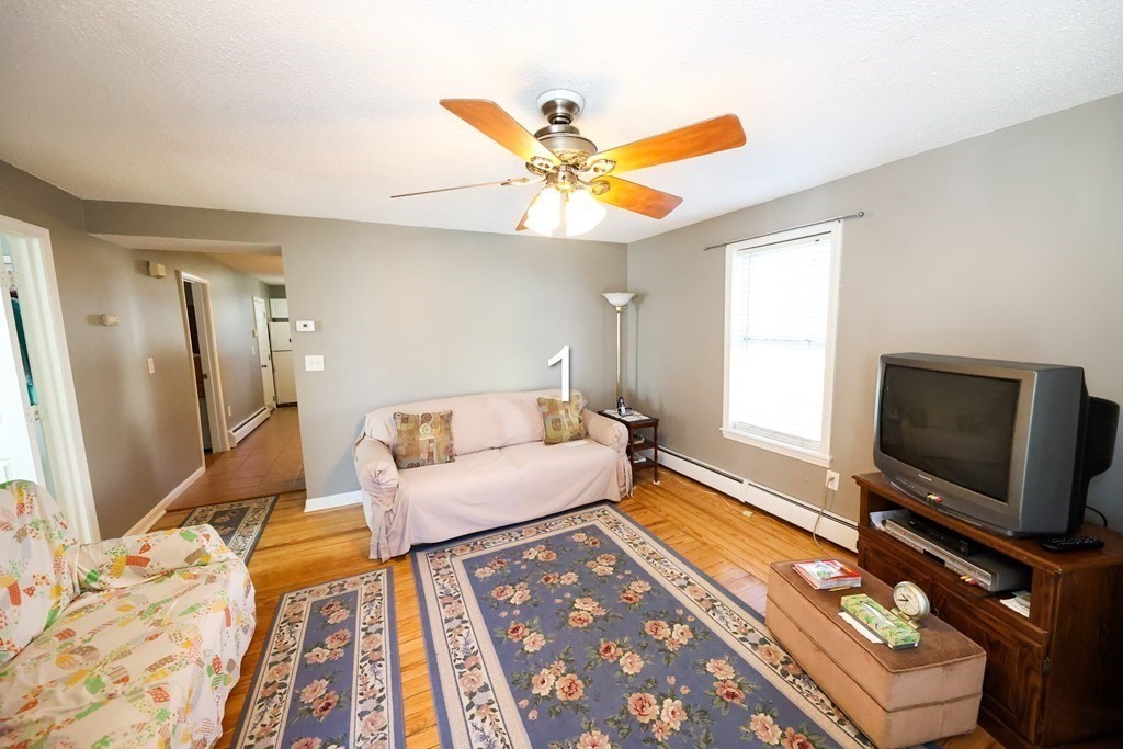 459 Snell Street Fall River, MA 02721 - Photo 17 of 42 a bedroom with a bed and a flat screen tv