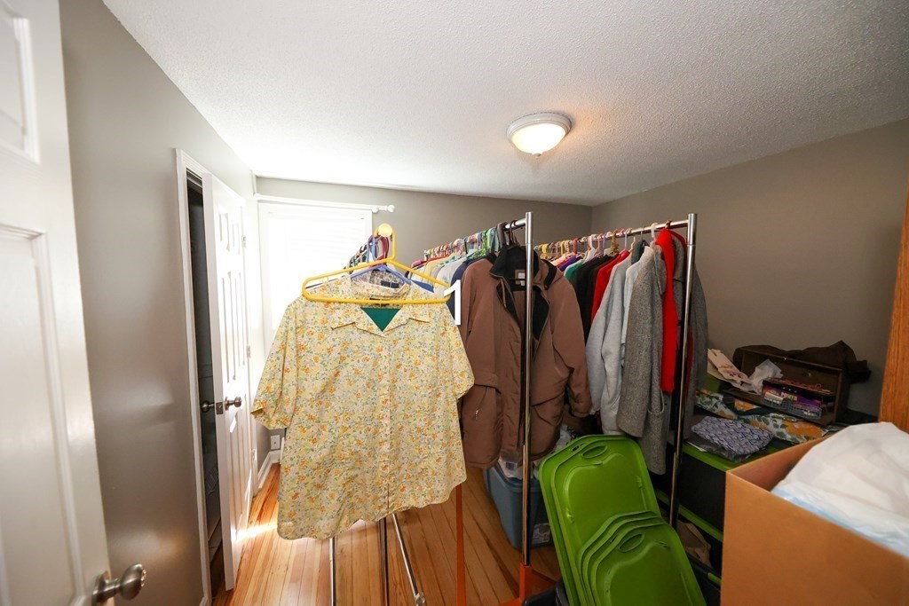 459 Snell Street Fall River, MA 02721 - Photo 20 of 42 a view of walk in closet with clothes and shoes