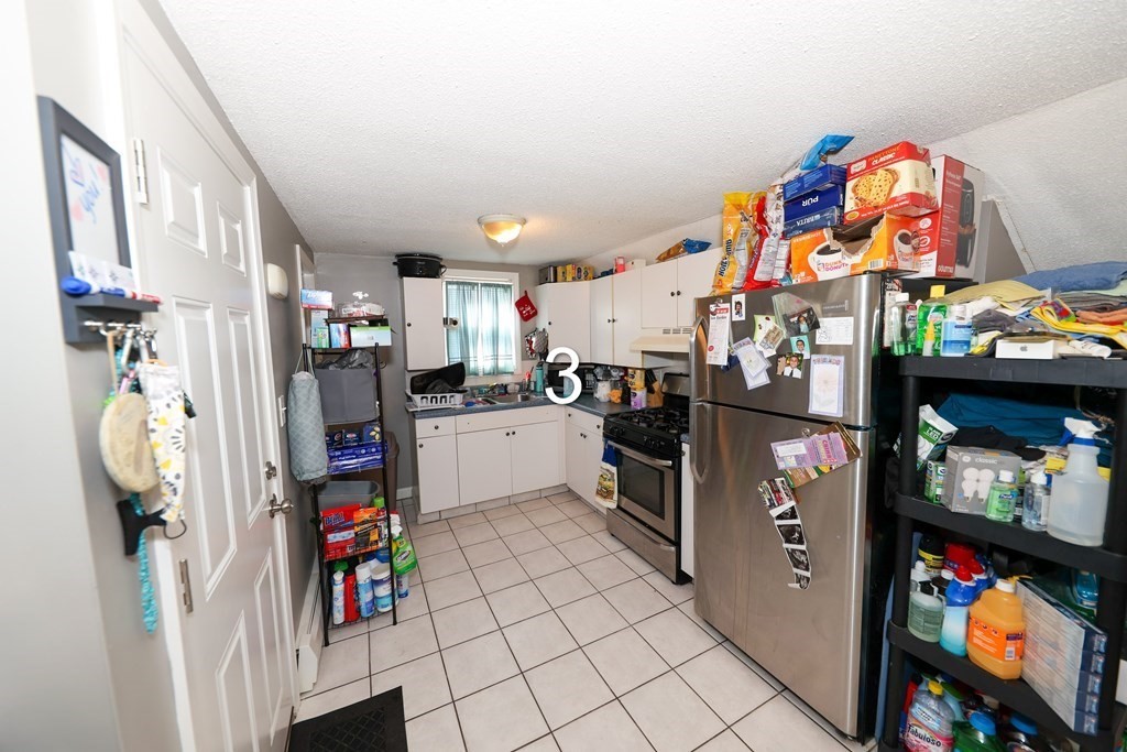 459 Snell Street Fall River, MA 02721 - Photo 22 of 42 a kitchen with stainless steel appliances granite countertop a refrigerator and a stove