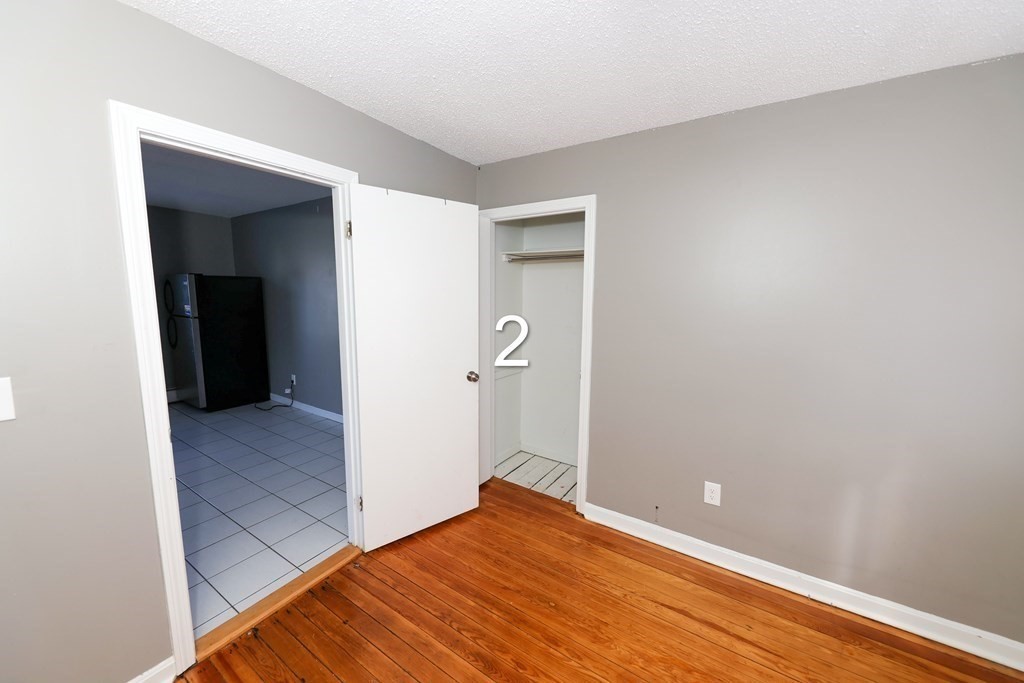 459 Snell Street Fall River, MA 02721 - Photo 6 of 42 a view of a big room with closet and wooden floor