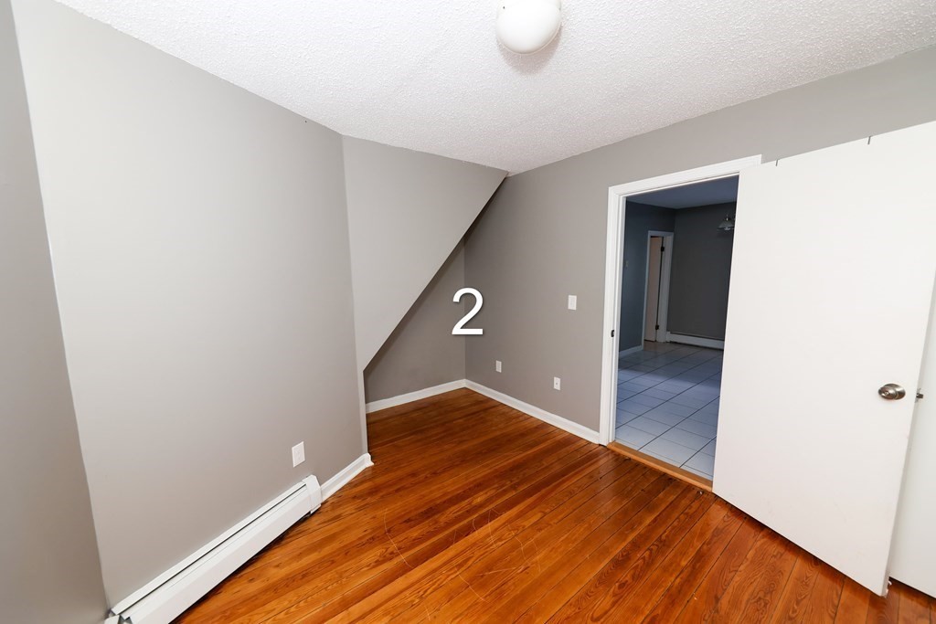 459 Snell Street Fall River, MA 02721 - Photo 7 of 42 a view of a hallway with wooden floor