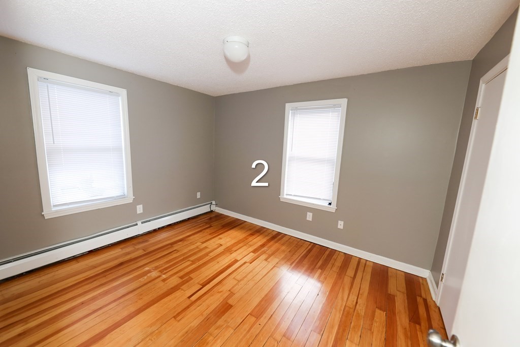 459 Snell Street Fall River, MA 02721 - Photo 8 of 42 a view of a room with wooden floor and window