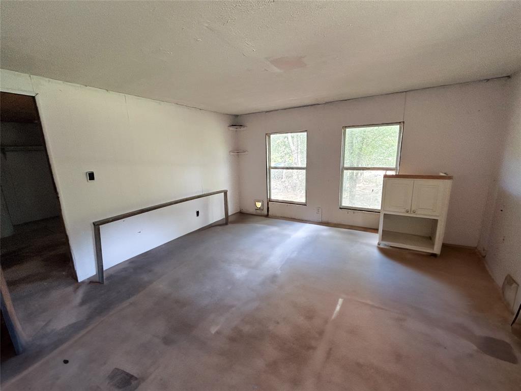 120 Timber Trail Mabank, TX 75156 - Photo 11 of 12 an empty room with windows and fireplace