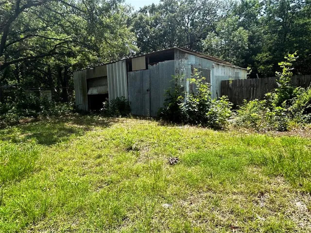 a front view of house with yard and trees