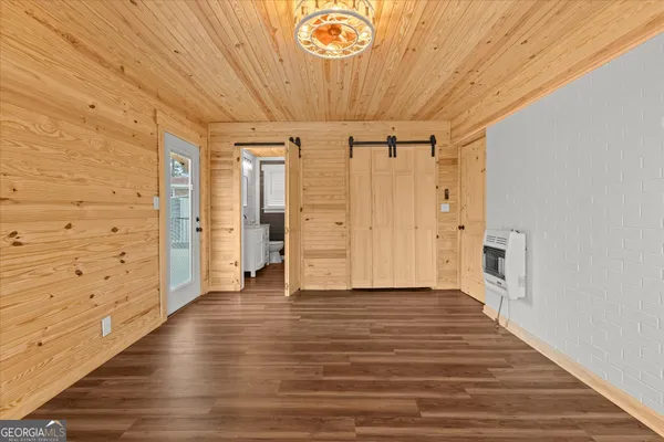 a view of a livingroom with wooden floor a ceiling fan