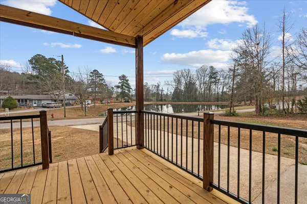 a view of a balcony with wooden floor & fence