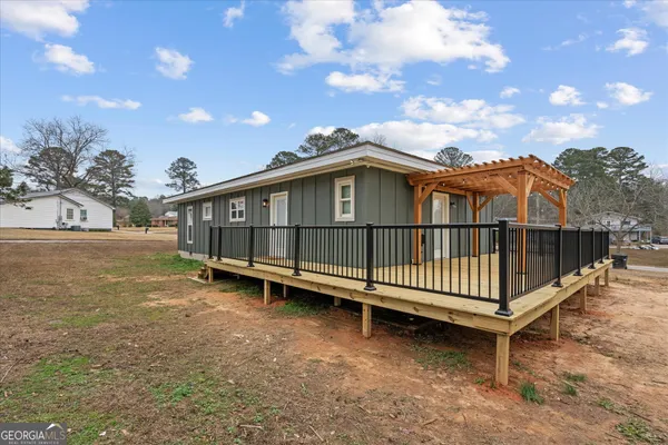 a view of a house with a wooden deck