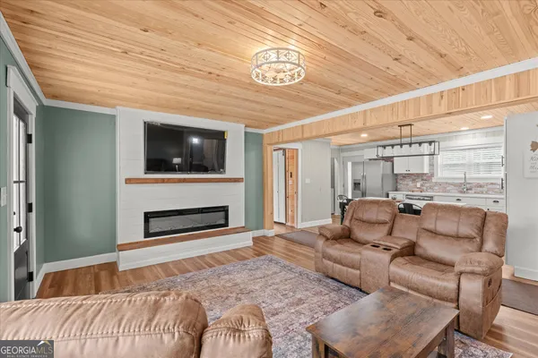 a bedroom with furniture and a flat screen tv