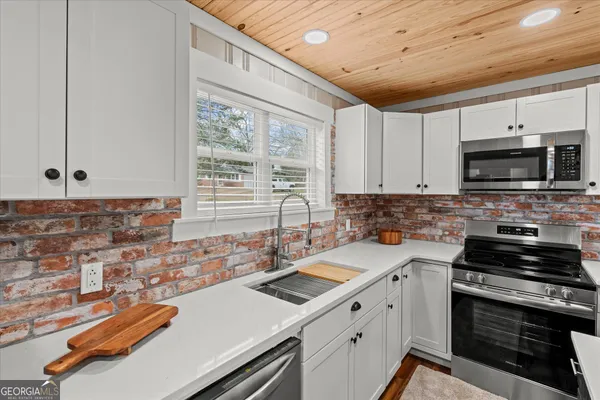 a kitchen that has a sink and a stove